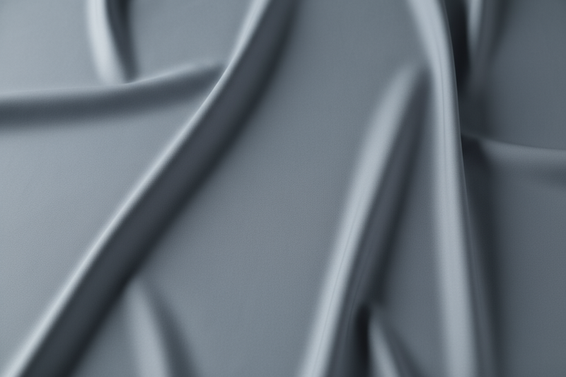 smooth soft matte stretch fabric, slate grey tone, soft studio light, no wrinkles, ultra-minimal close-up, quiet luxury aesthetic